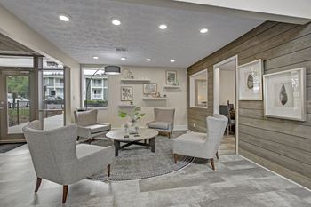 A living room with grey chairs and a coffee table.